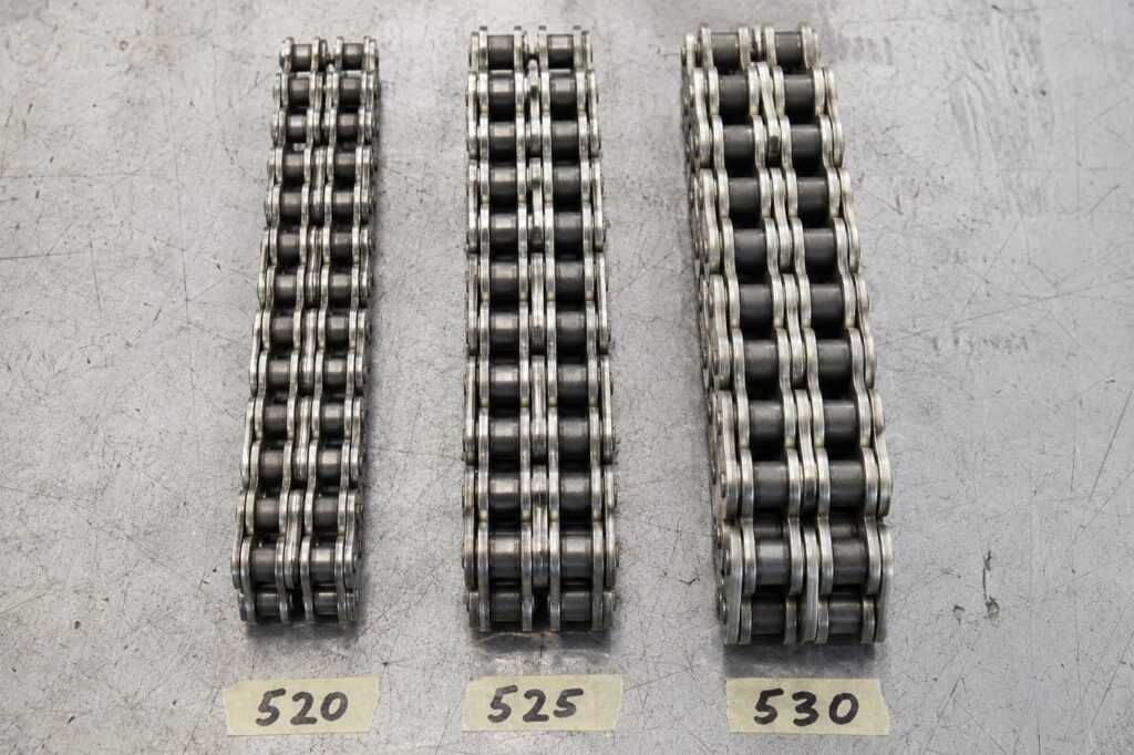 Three motorcycle chains showing 520 525 and 530 size differences side by side
