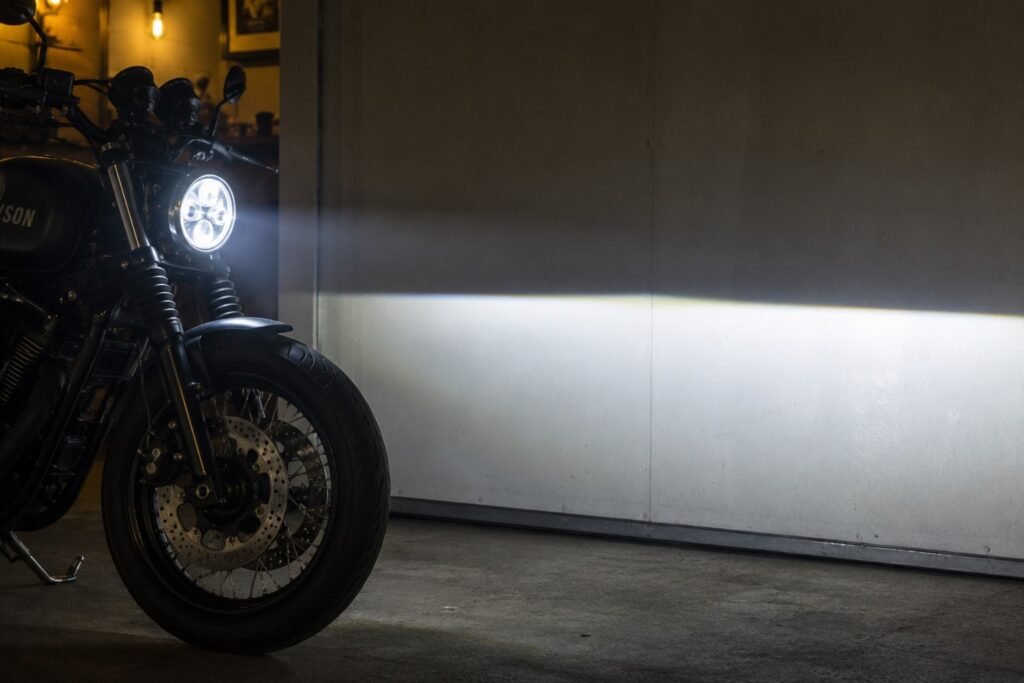 7 inch round LED projector headlight on motorcycle showing sharp beam cutoff line