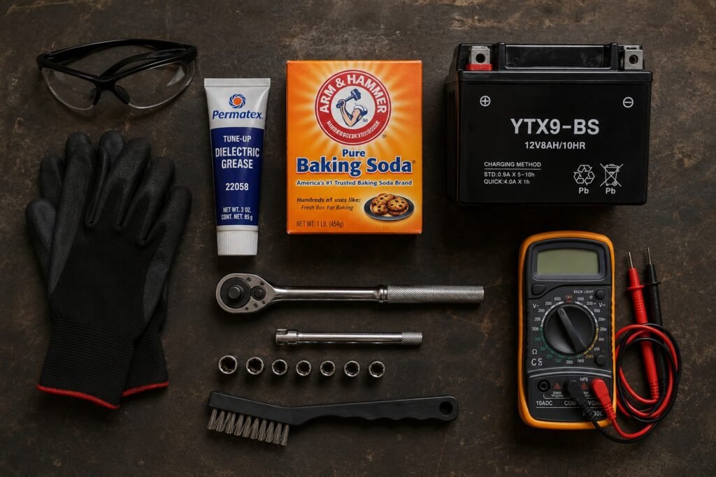 All tools needed for motorcycle battery replacement laid out on a workbench