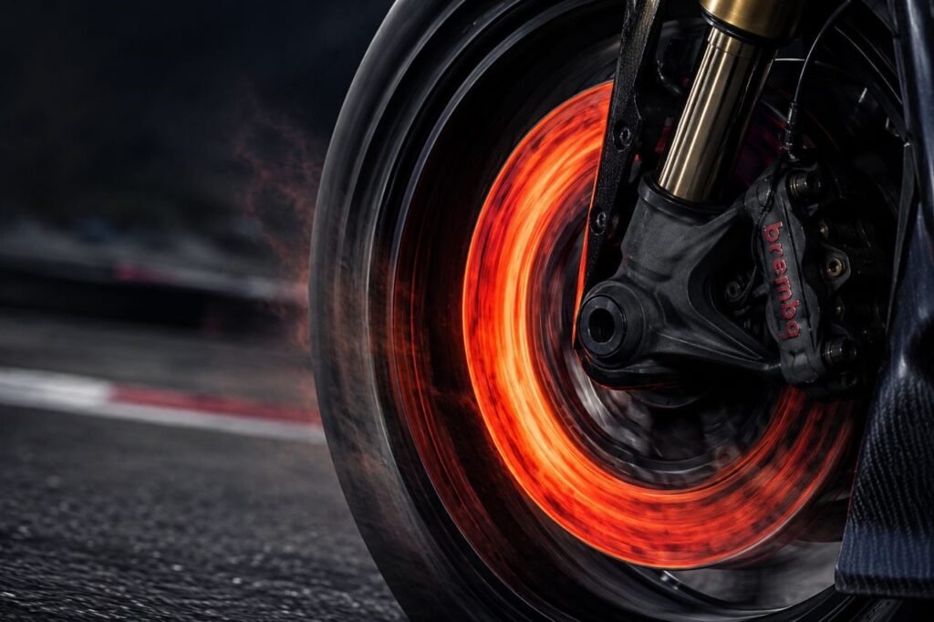 Red-hot motorcycle brake disc showing heat buildup that causes brake fade