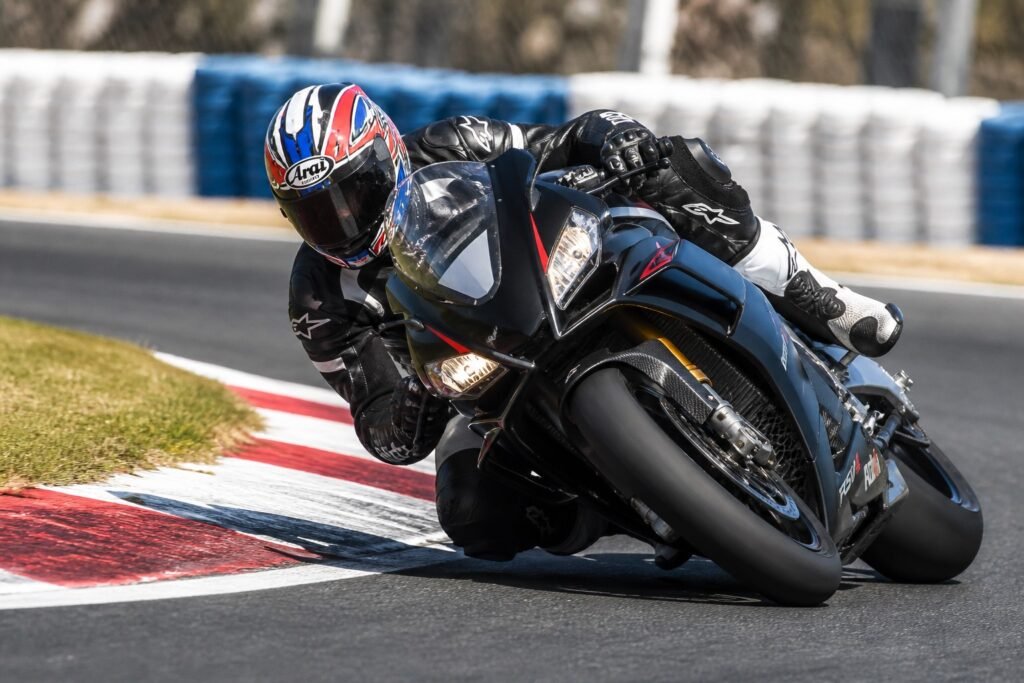 Sport motorcycle track racer cornering at speed showing performance benefits of lithium battery upgrade