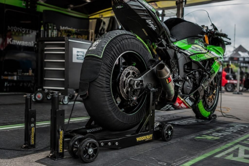 Woodcraft adjustable rear superbike stand with quad wheels at racetrack