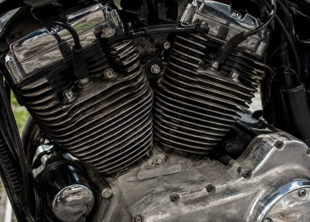 Mechanical close-up showing the chrome and cooling fins of a heavy air-cooled V-twin motorcycle engine block.