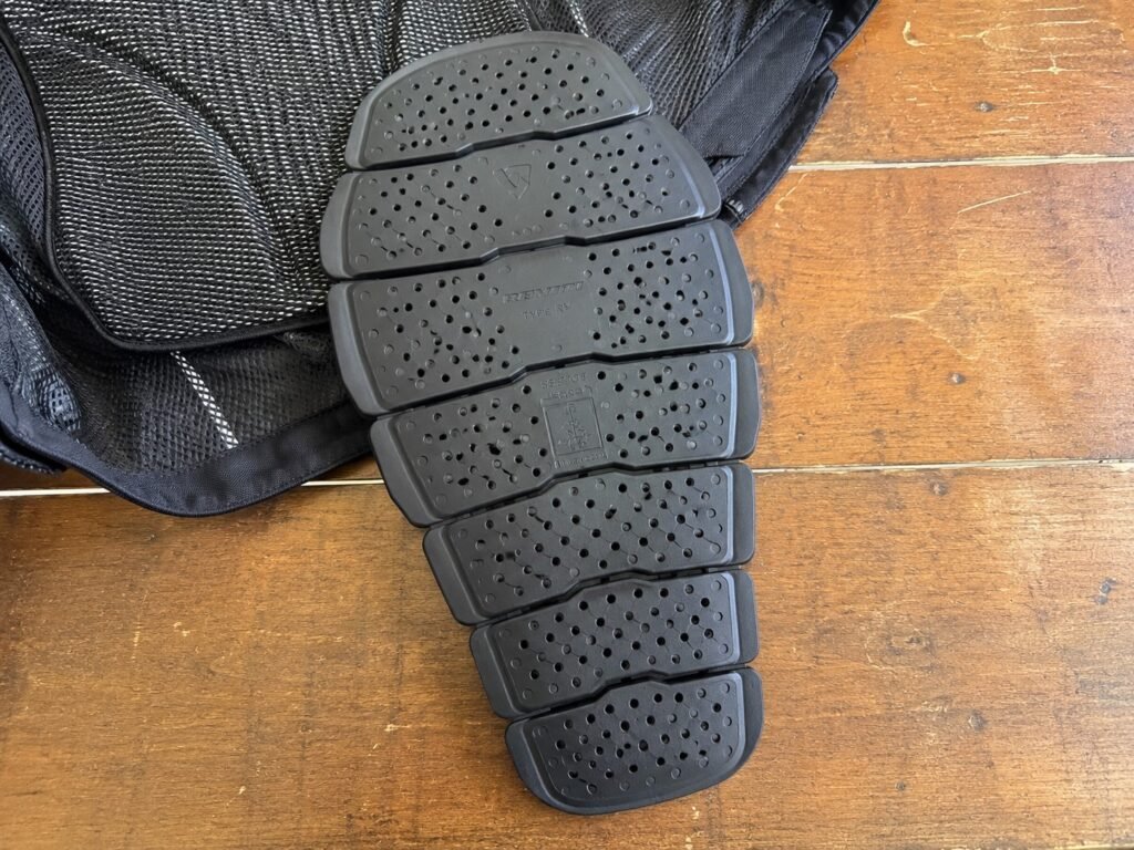 CE Level 2 motorcycle back protector insert removed from jacket showing segmented armor plates