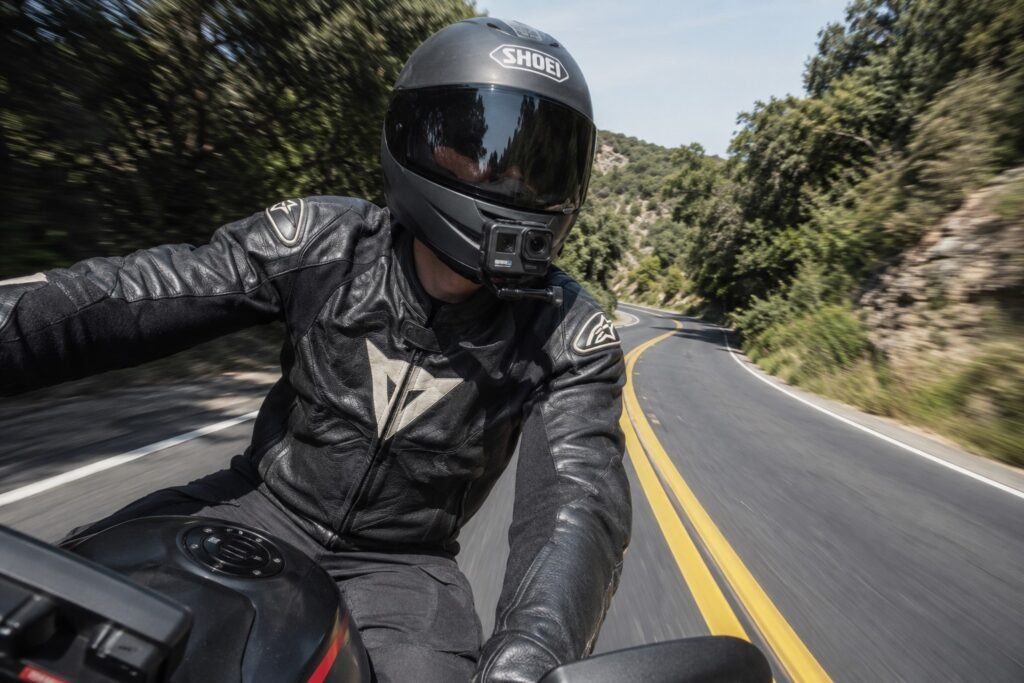 Rider with action camera mounted on motorcycle helmet during GoPro vs DJI Osmo Action motorcycle test