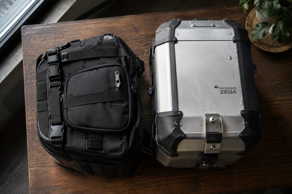 Hardshell and soft-sided motorcycle tail bags shown next to each other