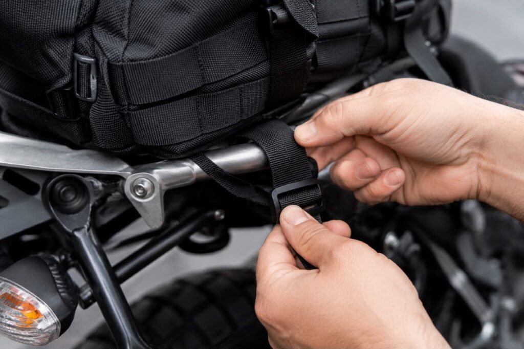Close-up of straps attaching a motorcycle tail bag to the rear subframe
