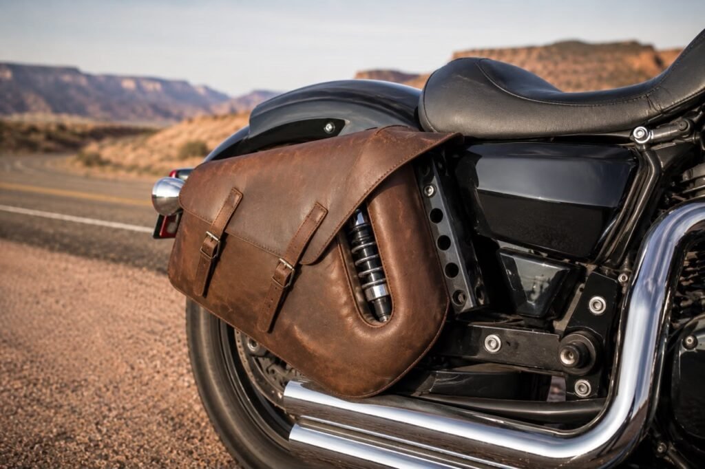 Leather slant saddlebag mounted on cruiser motorcycle with shock cutout