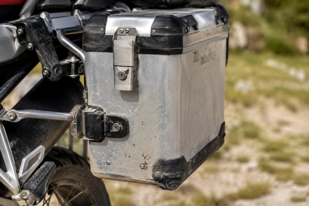 Close-up of a lockable aluminum hard saddlebag mounted on a touring motorcycle