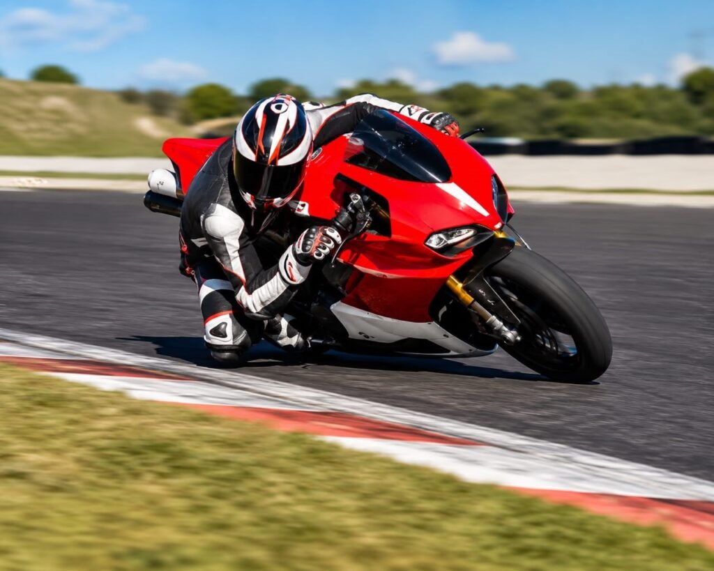 Sportbike rider leaned into a corner using a motorcycle quickshifter for a smooth mid-lean upshift