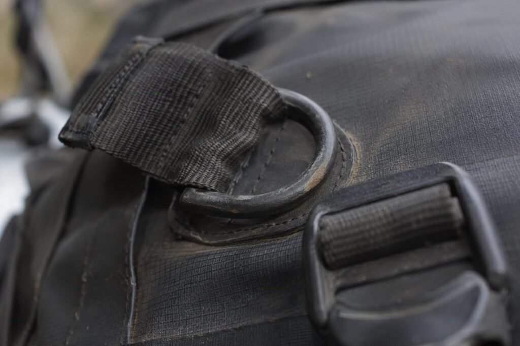 Close-up of D-ring hardware on a motorcycle tail bag