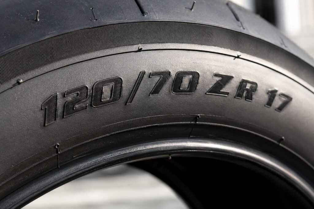 Close-up of motorcycle tire sidewall showing size numbers and letters