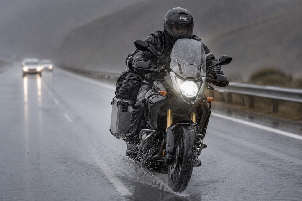 Motorcycle rider on highway in rain with waterproof touring luggage