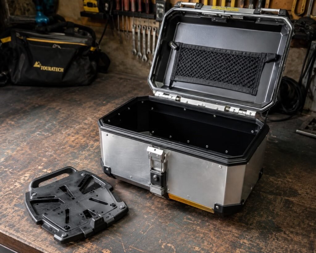 Motorcycle top box with quick-release mount and key lock cylinder visible