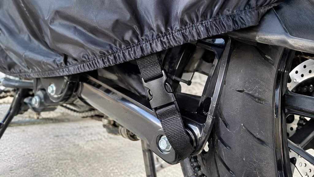 Elastic hem and buckle strap on a well-fitted motorcycle cover
